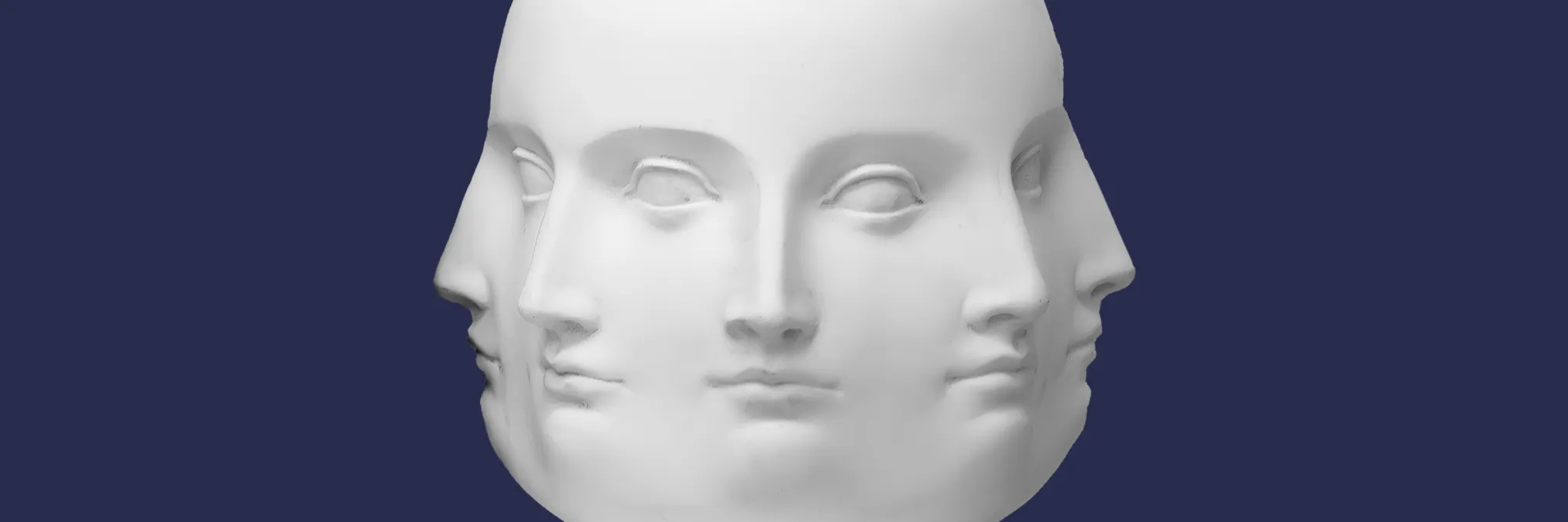 Photograph of a vase sculpture with 5 visible faces around its facets.